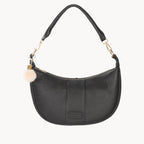 Black handbag with a decorative charm on a white background