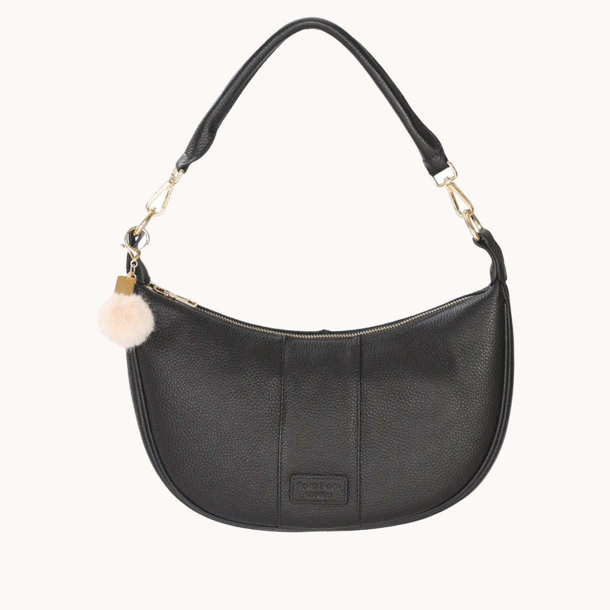 Black handbag with a decorative charm on a white background