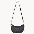 Black shoulder bag with a strap on a white background