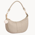Stone handbag with a gold chain and white pom-pom on a light gray background
