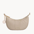 Stone handbag with a gold chain and white pom-pom on a light gray background