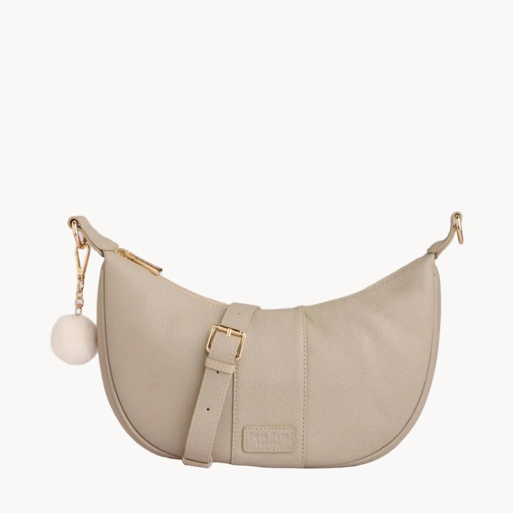 Stone handbag with gold accents on a light gray background
