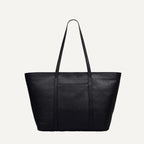 Black leather tote bag on a light gray background