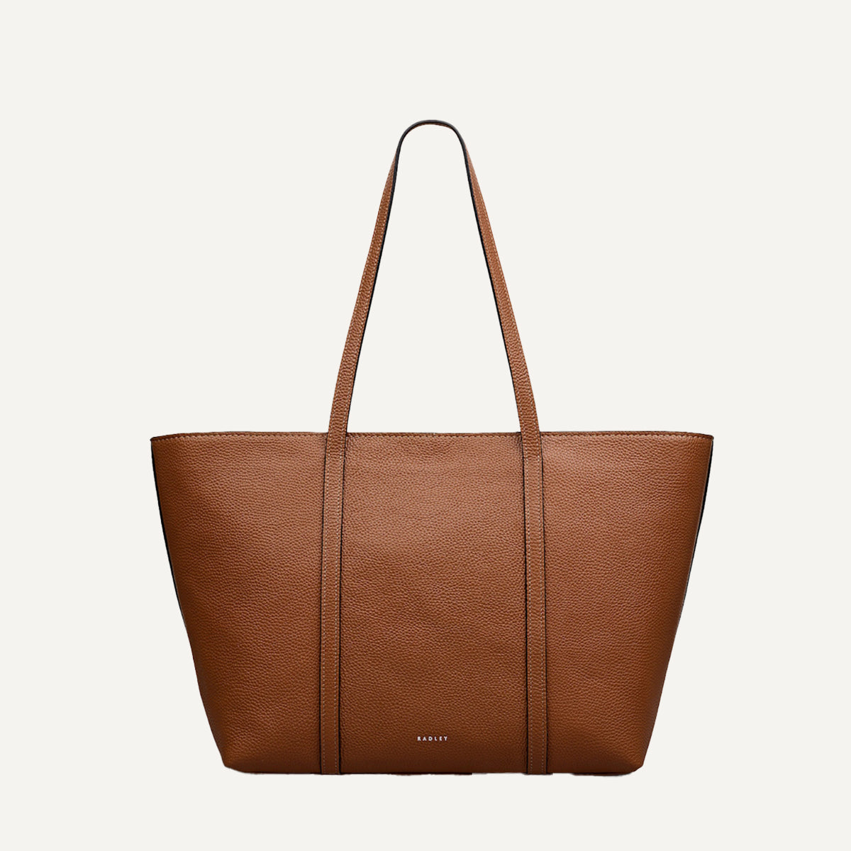 Brown leather tote bag on a light beige background