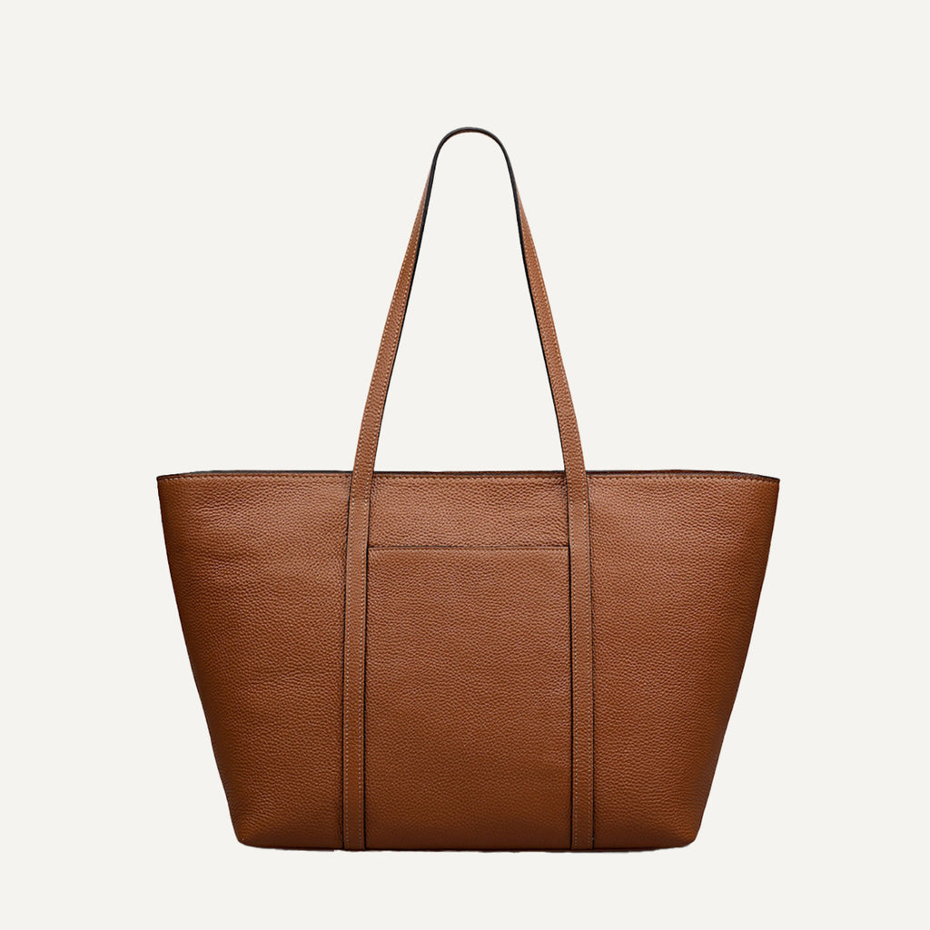 Brown leather tote bag on a light beige background