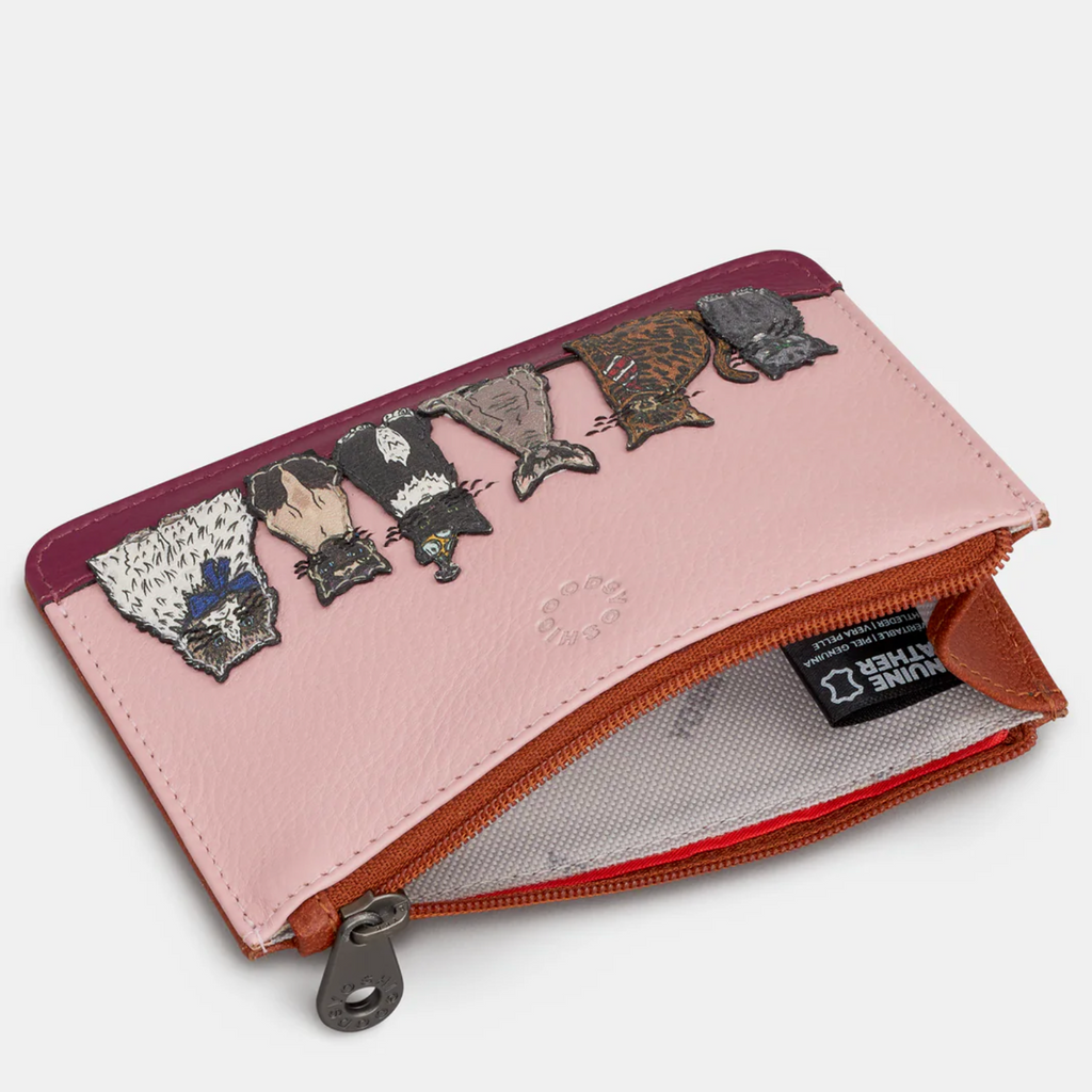 Pink wallet with lace appliqués on a white background