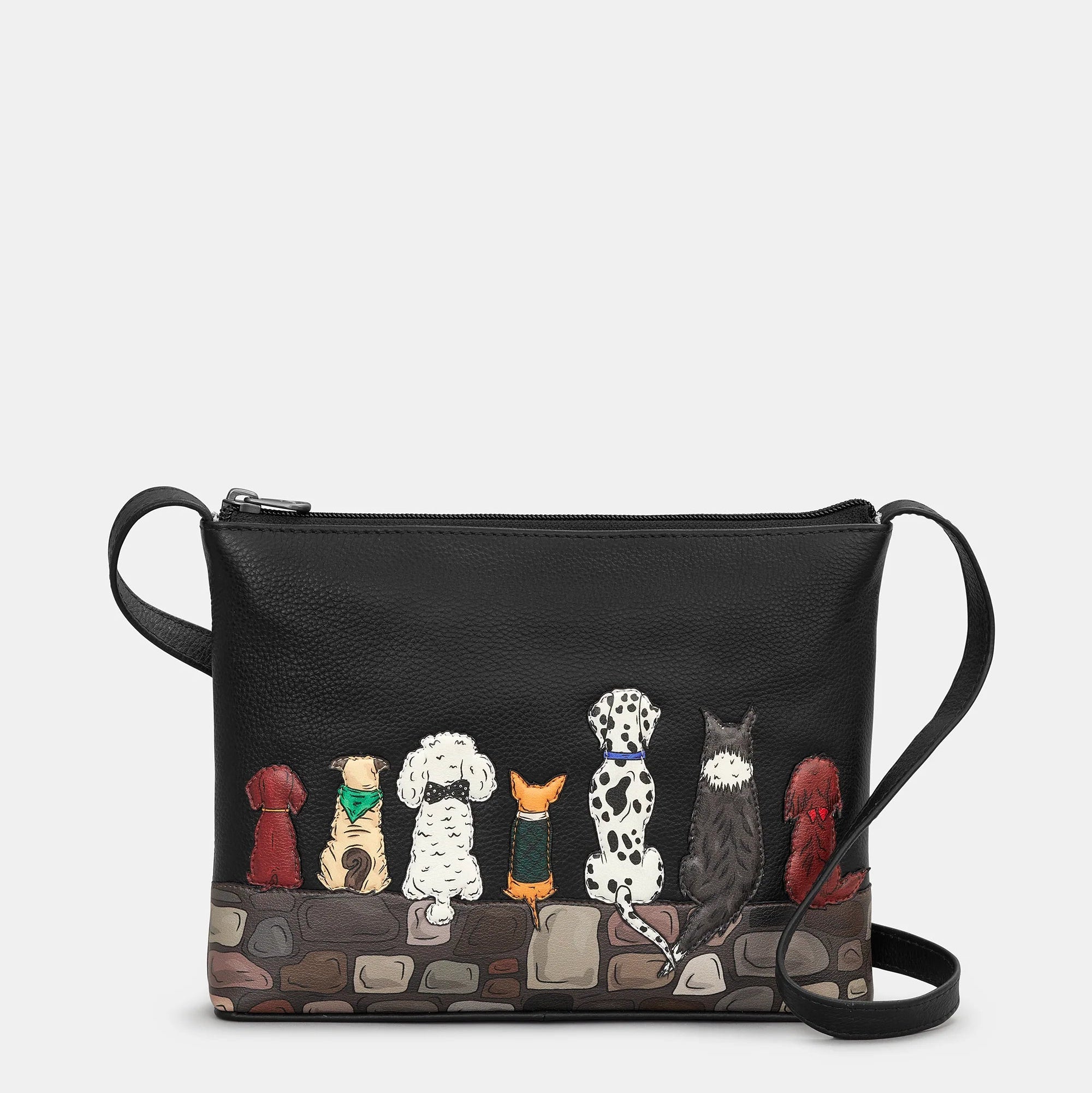 Black handbag with dog illustrations on a white background