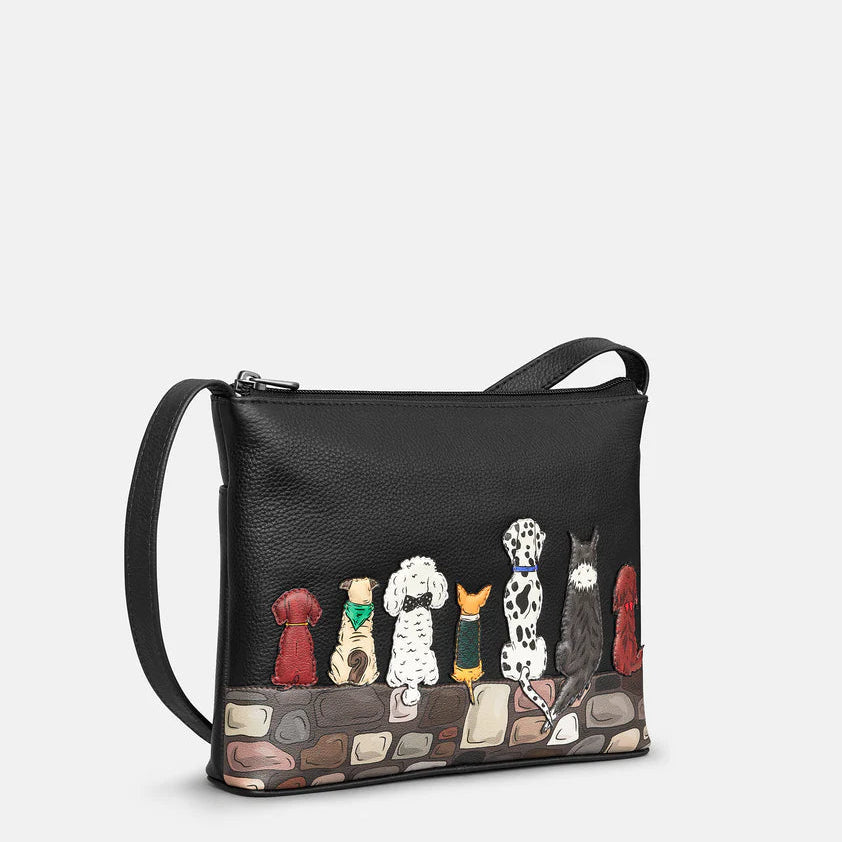 Black handbag with dog illustrations on a white background