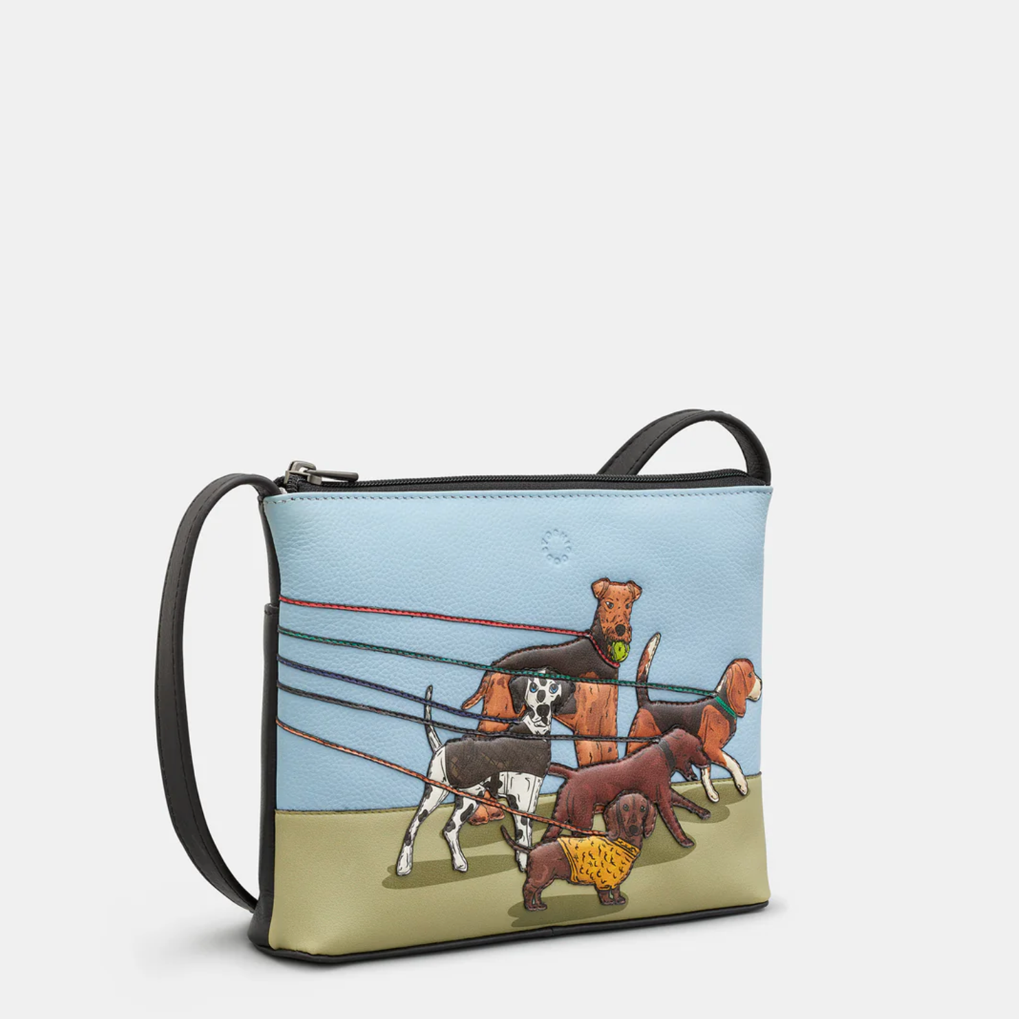 Leather crossbody bag with appliqué dog walk design in blue, green and brown.