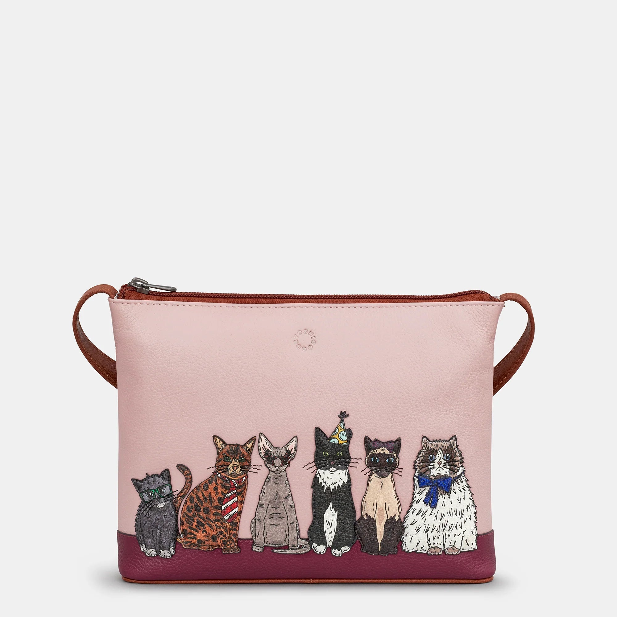 Crossbody bag with illustrations of cats on a pink background