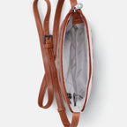 Inside view of brown leather bag with a strap on a white background
