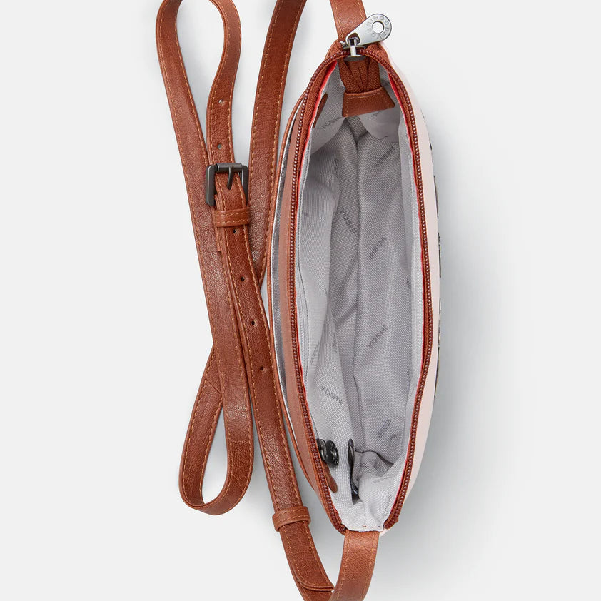 Inside view of brown leather bag with a strap on a white background