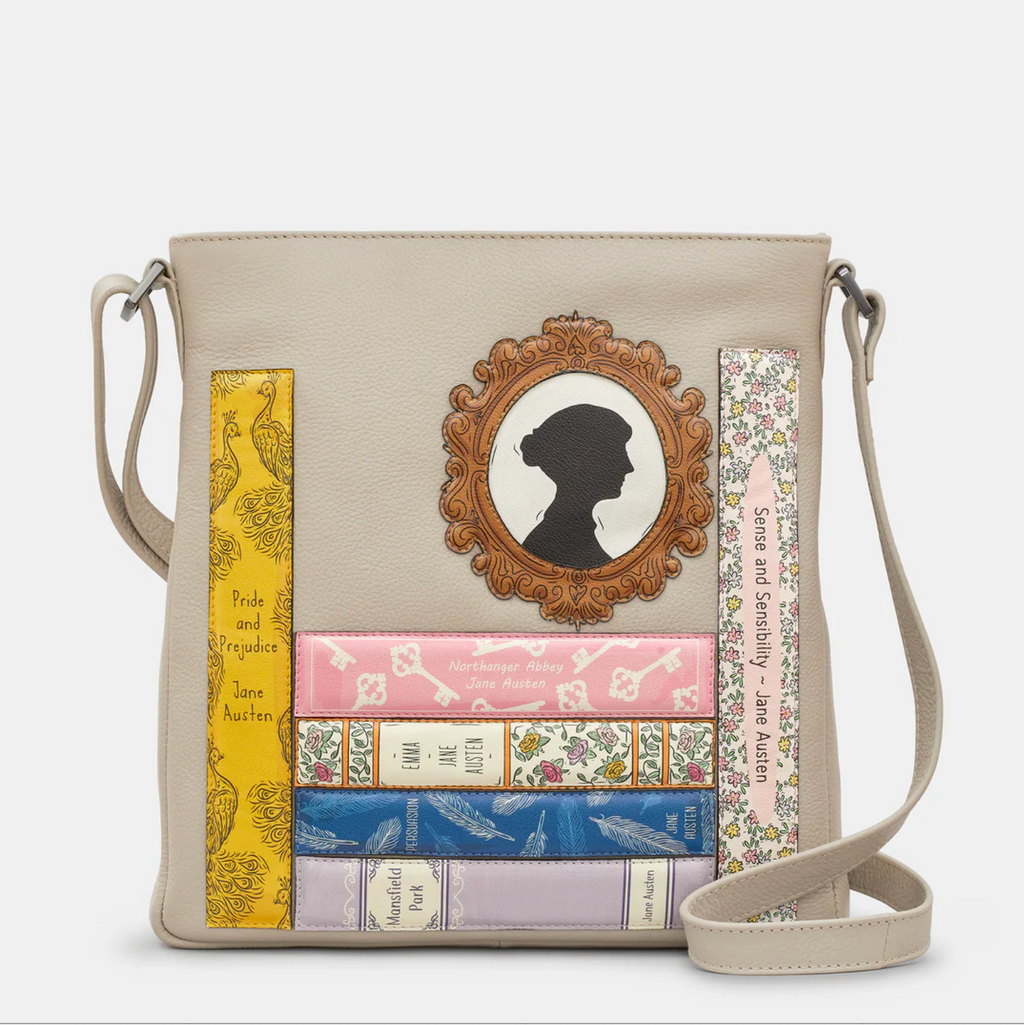 Leather crossbody bag in warm grey with appliqué Jane Austin books and portrait design on front.
