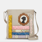 Leather crossbody bag in warm grey with appliqué Jane Austin books and portrait design on front.
