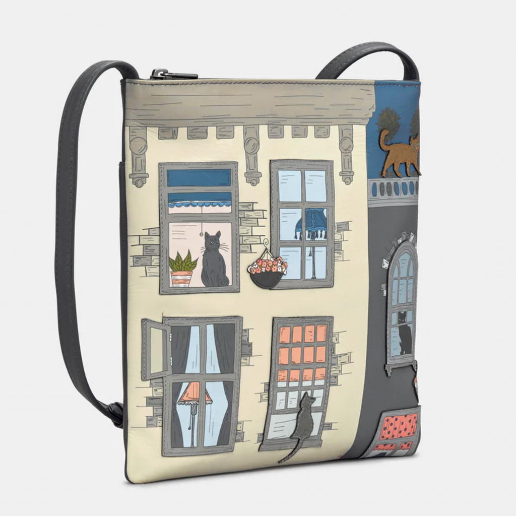 Crossbody bag with a design of cats by windows on a beige background