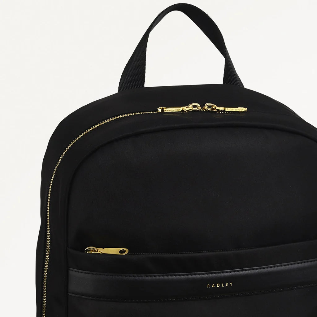 Black backpack with gold zippers on a white background