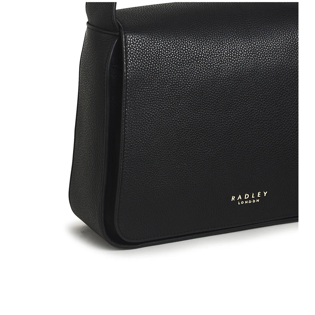 Radley Westwell Lane Medium Flapover Crossbody Bag in Black - detail of metal logo letters and magnetic fastening