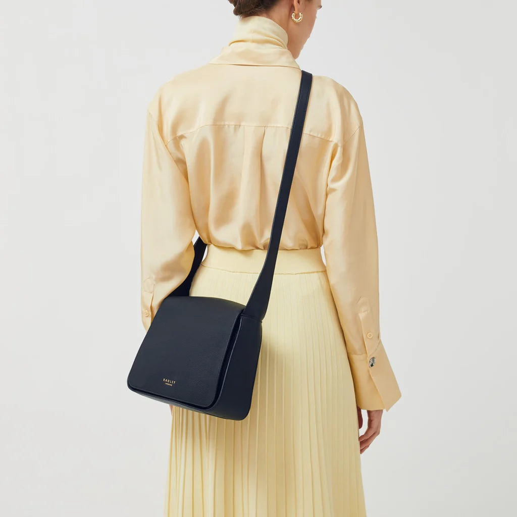 Radley Westwell Lane Medium Flapover Crossbody Bag in Ink - lifestyle shot showing everyday crossbody wear