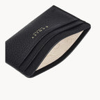 Black leather cardholder with visible brand name on a white background